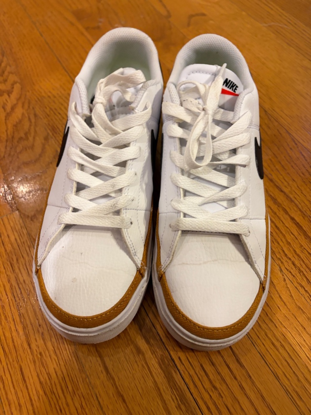 Nike White Low-Top Sneakers with Brown Trim and Black Swoosh